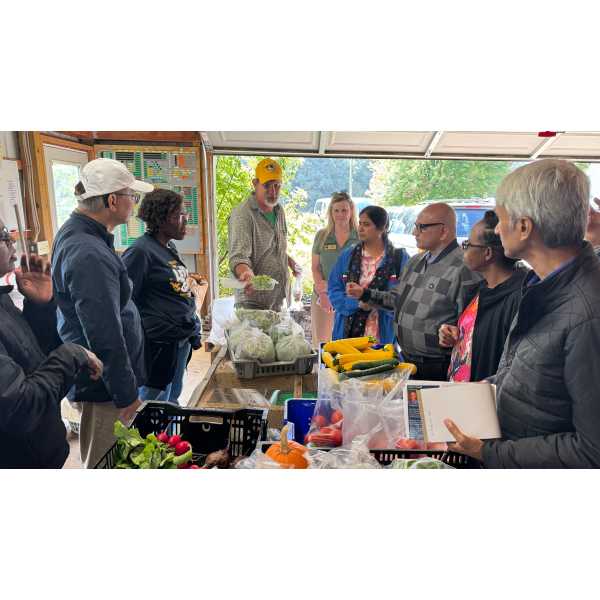 Mark Cowell of Blue Stone Organic Farm discussing his farm with the delegation.