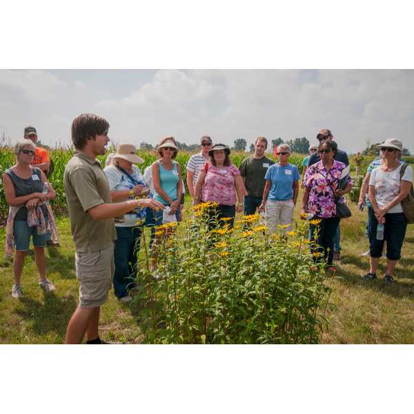 Student Logan Rowe shares information at a native plants for beneficial insects field day