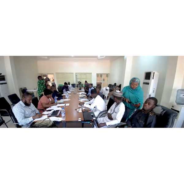 Attendees at a RSM2SNF event, sitting at a long table in a conference room.