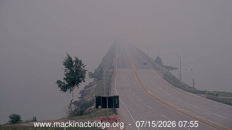 The Mackinac Bridge fading away in the background as smoke obscures sight.