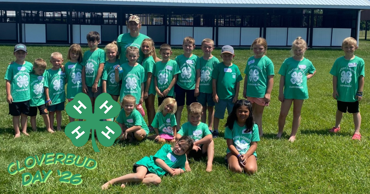 A group of young youth in matching green tshirts with a 4-H clover on it.