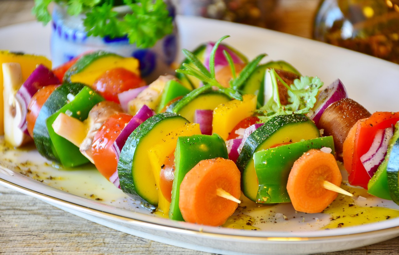 Vegetable skewers with paprika, peppers, onion, carrots on a plate
