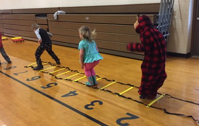 ECE Brain Breaks 2019.jpg Children engage in physical activity as they jump along a number line for a math lesson.