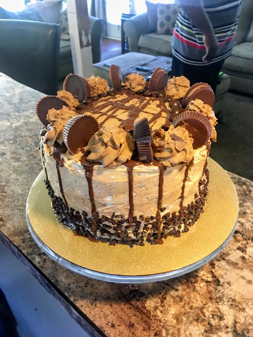 Chocolate cake with A peanut butter buttercream frosting with Reese&rsquo;s peanut butter cups and chocolate drizzle